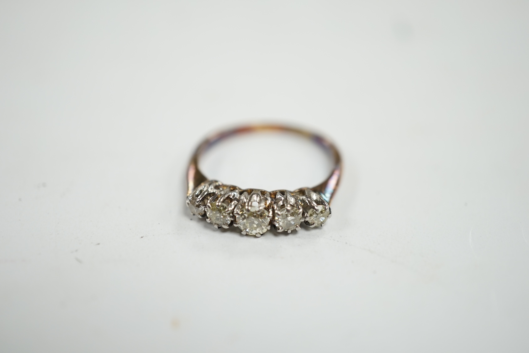 An 18ct and graduated five stone diamond set half hoop ring, size L, gross weight 2.8 grams. Condition - poor to fair